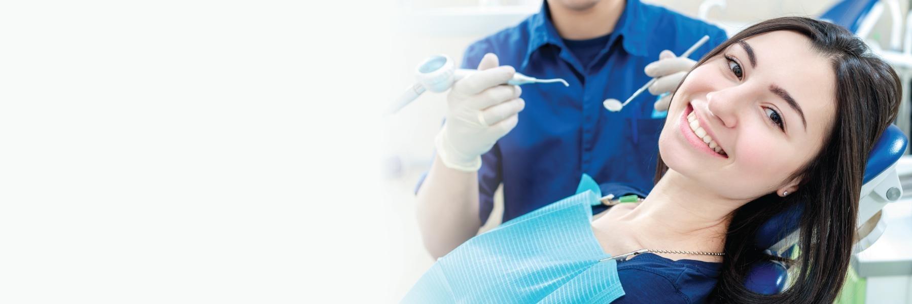 Woman receiving dental exam smiling l Dental exams red deer county AB