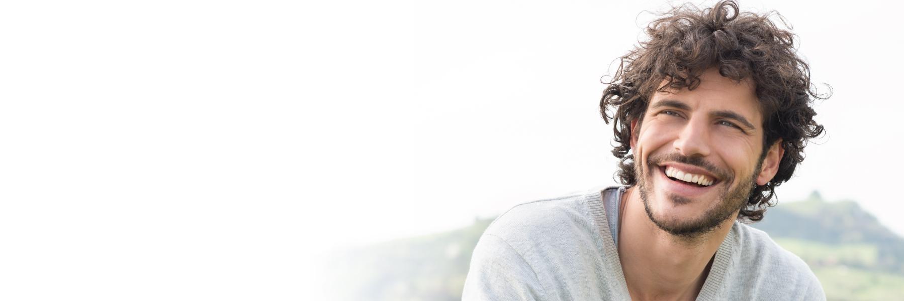 Young man smiling l Teeth whitening red deer county AB